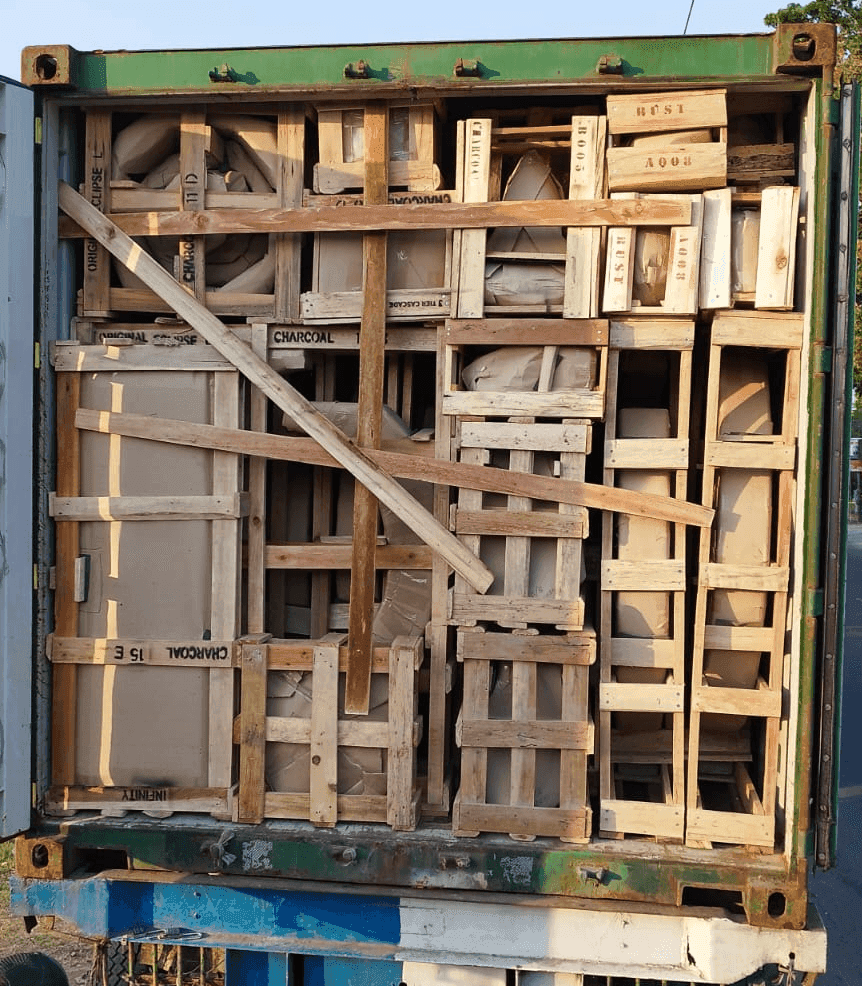 A loose-loaded container: fountains hand-stacked and braced with timber